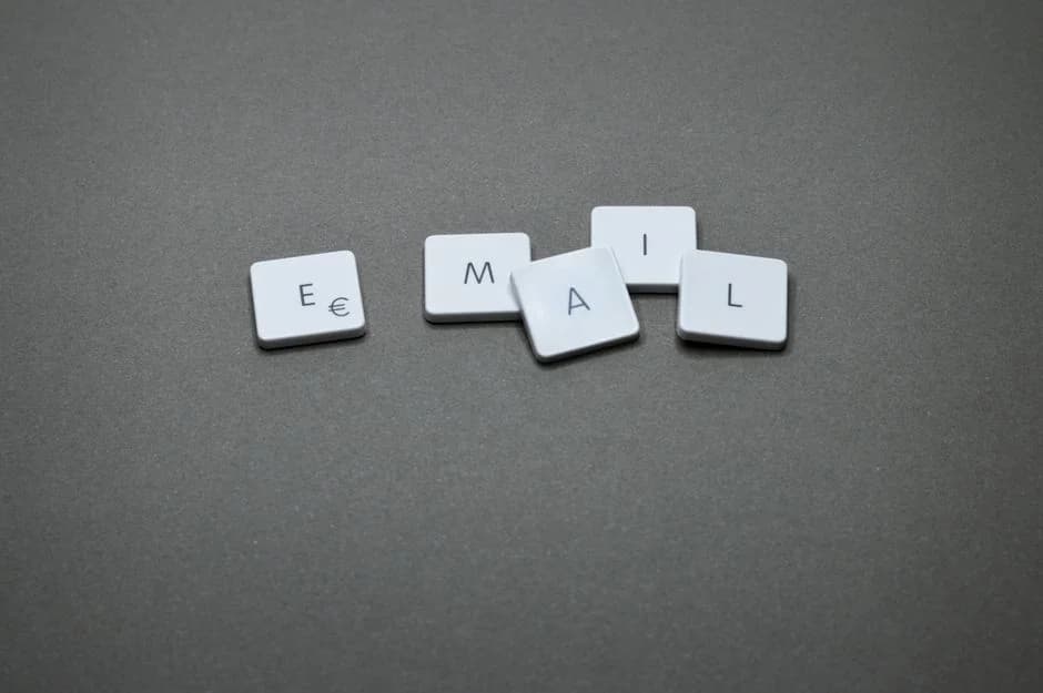Close-up of letter tiles forming 'email' on a gray surface, illustrating cold email infrastructure and pre-warmed inboxe