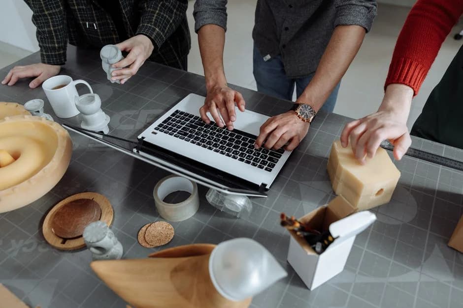 Small team collaborates in a workshop, blending hands-on crafting with digital tools to explore build-vs-buy GTM solutio