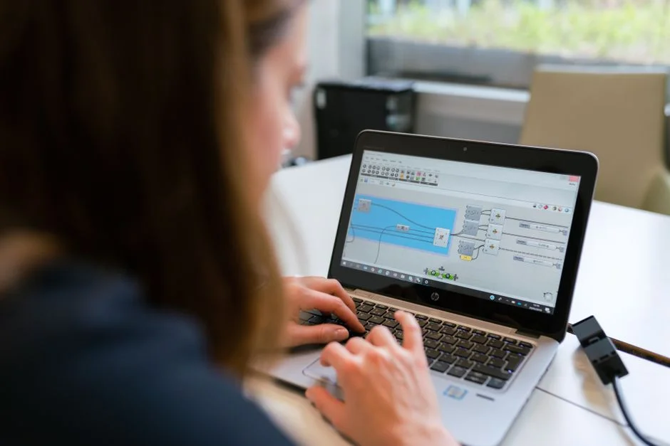 A woman engineer analyzes CRM data on her laptop indoors, automating a data quality cleanup workflow.