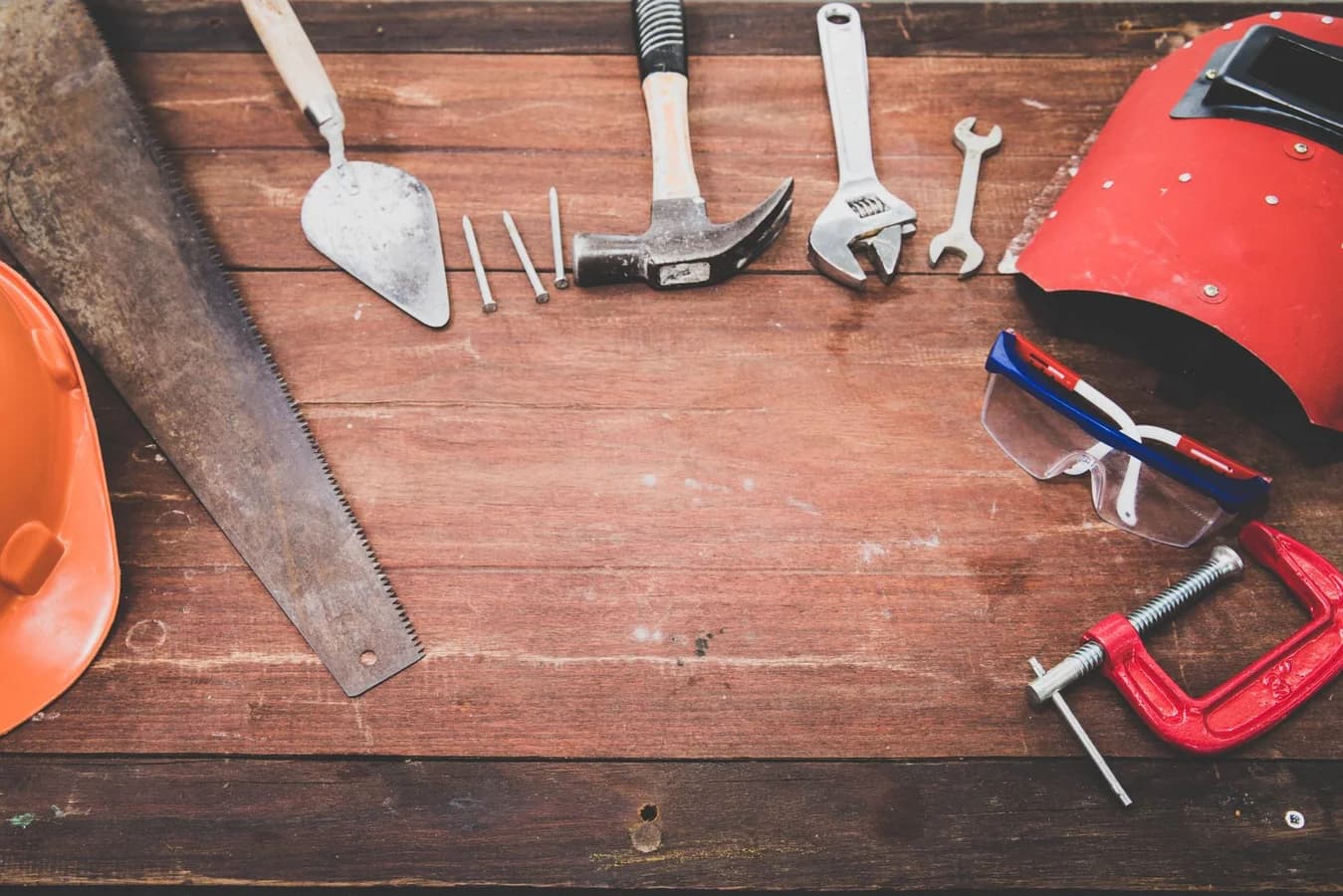 Hand tools laid out on a wooden workbench