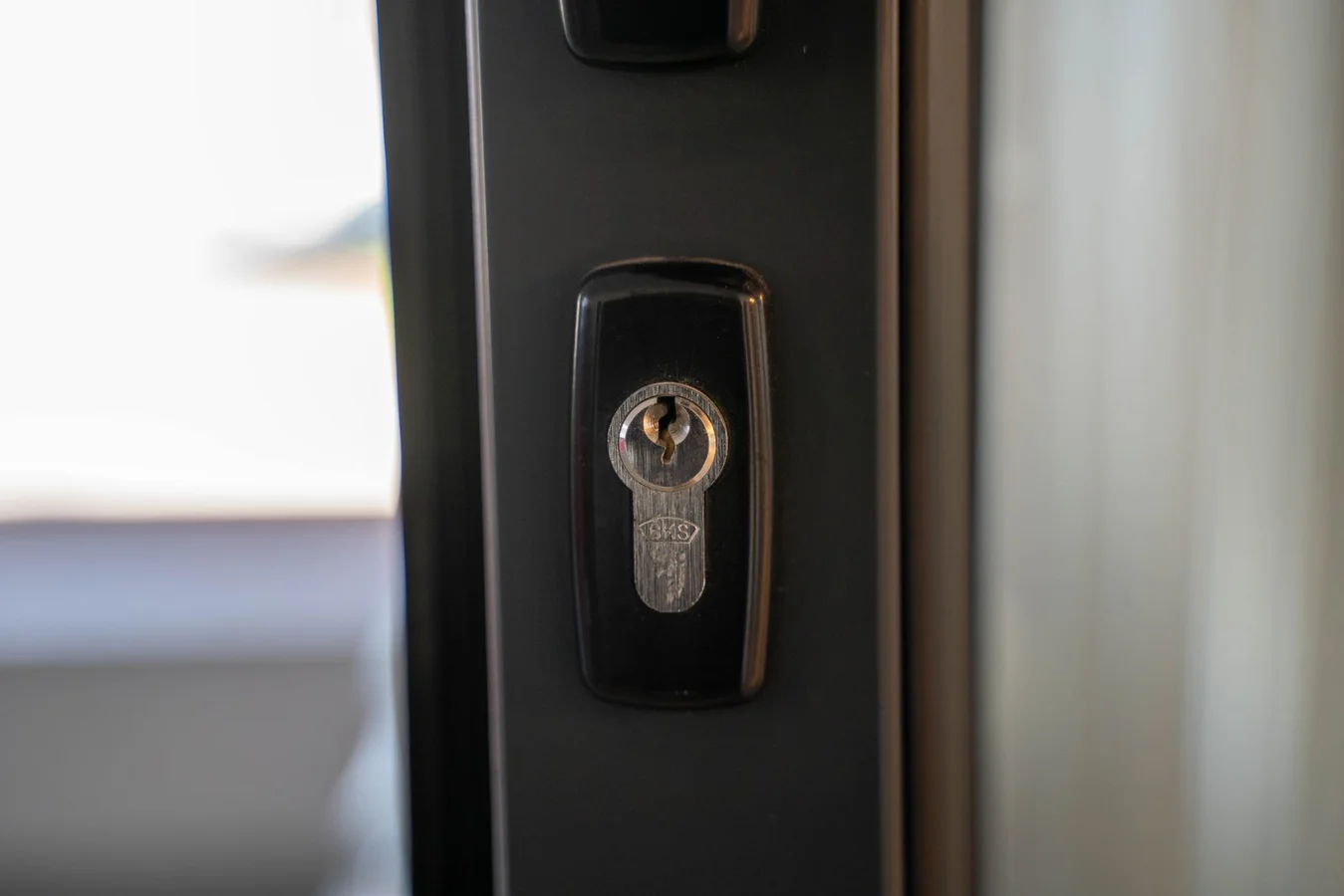 Close up of a steel keyhole set into a door
