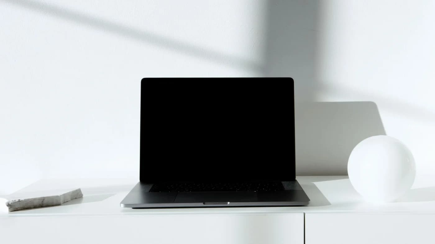 Laptop on a clean white desk with natural light