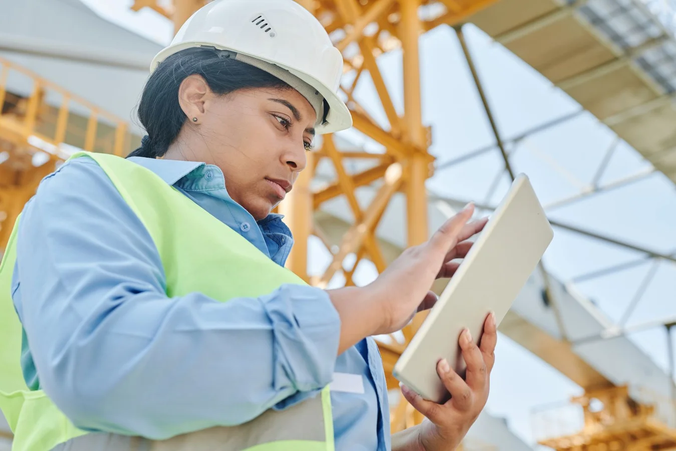Site engineer checking a tablet on a construction site